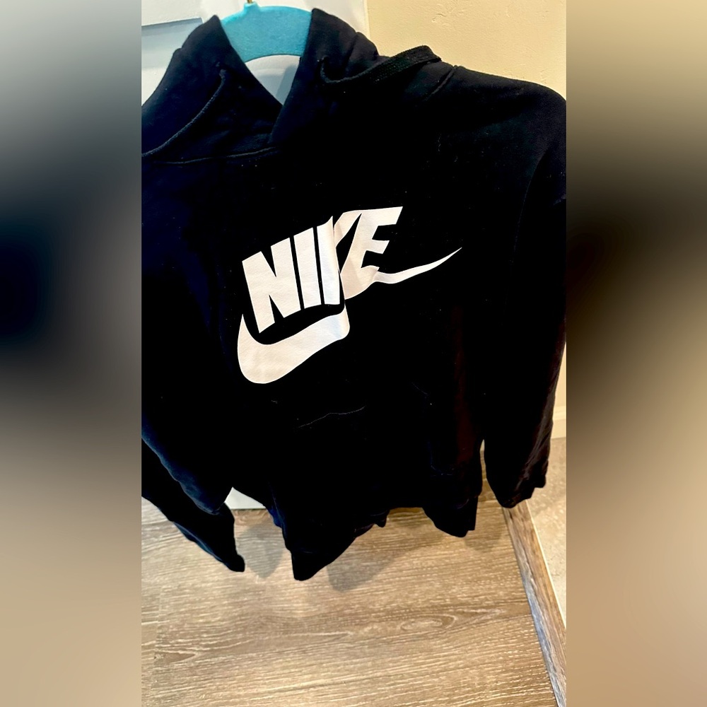 Two hoodies. Nike women’s black hoodie, wore less than 10 times Reebok size M